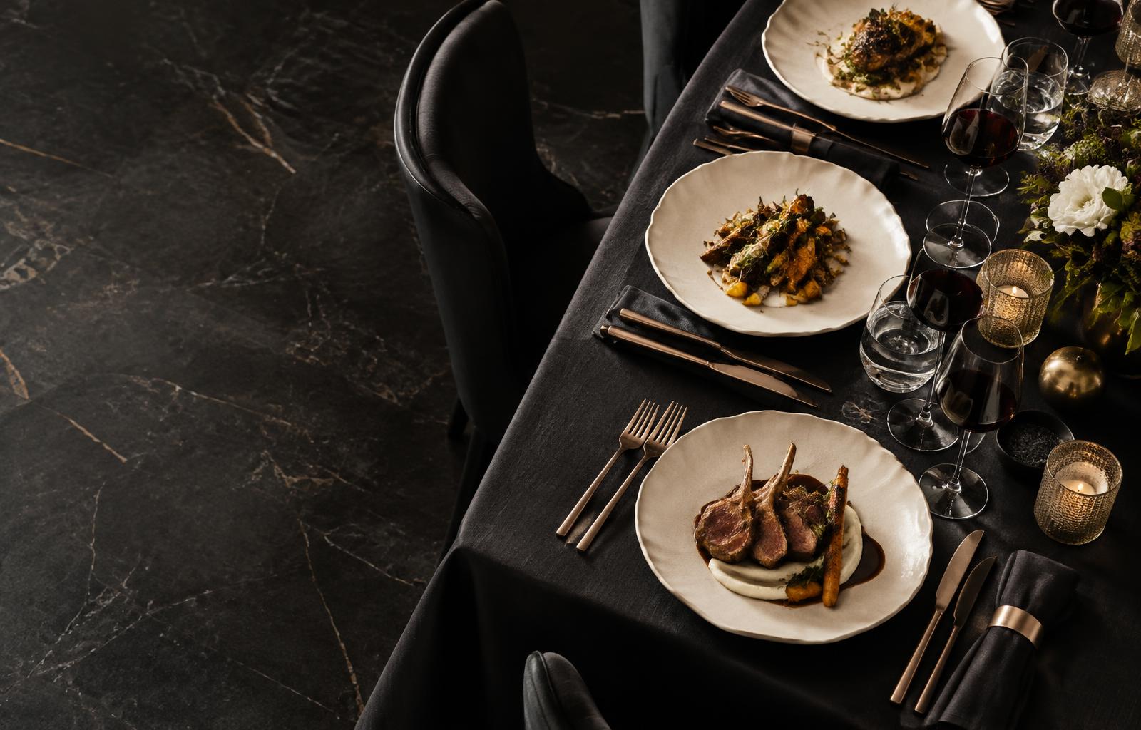 Illustrative private dining table with plated lamb and bronze cutlery